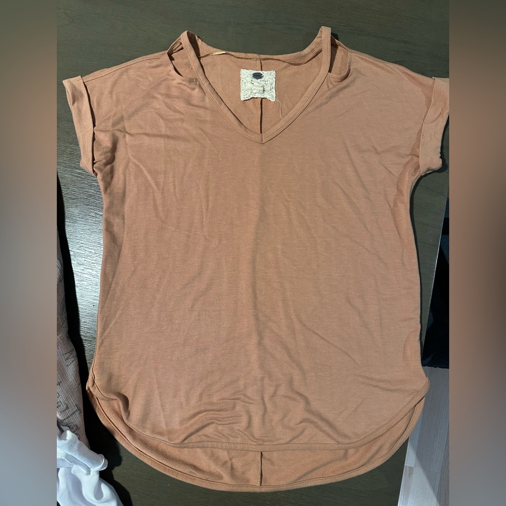 Chic and comfortable V-neck tee. Soft fabric with rolled sleeves.
